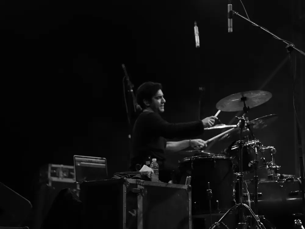 A drummer at the kit, in black and white