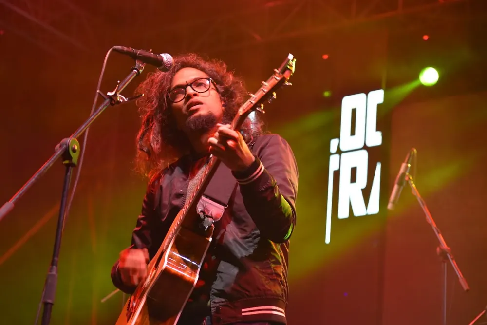 A guitarist at the microphone in red and green light