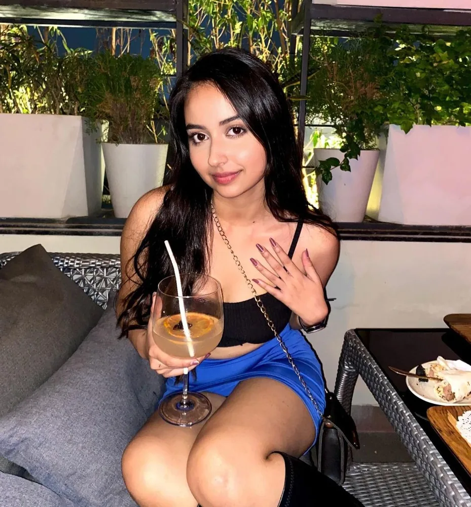 A creator with a drink, on a rooftop