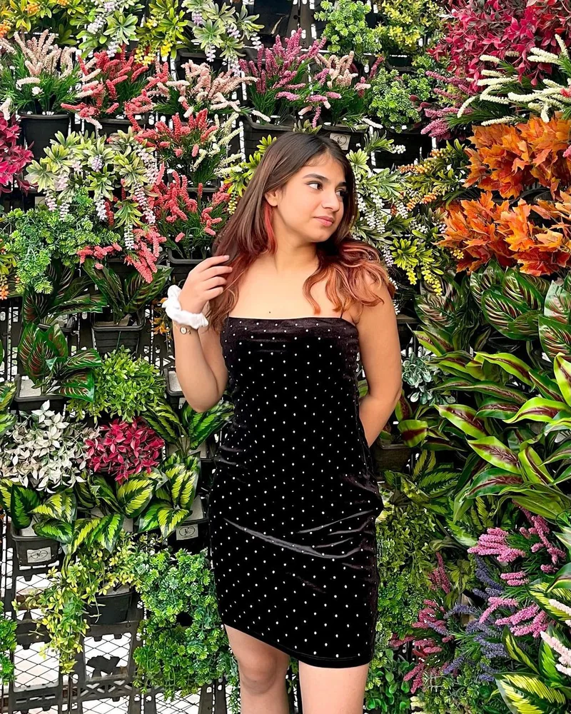 A creator at a flower wall